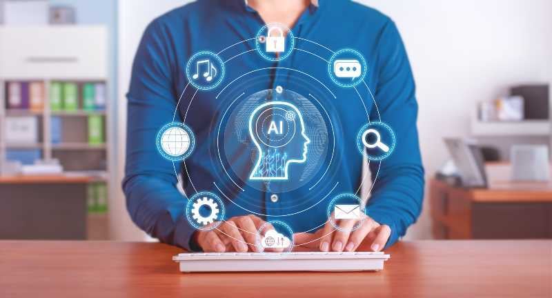 ai marketing professional at a keyboard showing ai marketging icons with an ai icon at the centre