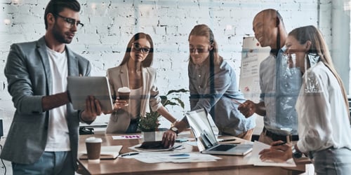 Blended ABM vs. Demand Gen a team having the strategic discussion in an office