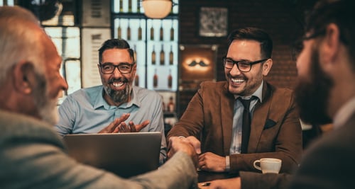 Happy customers shaking hands on a business deal