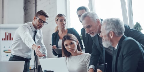 team of buyers looking at a computer
